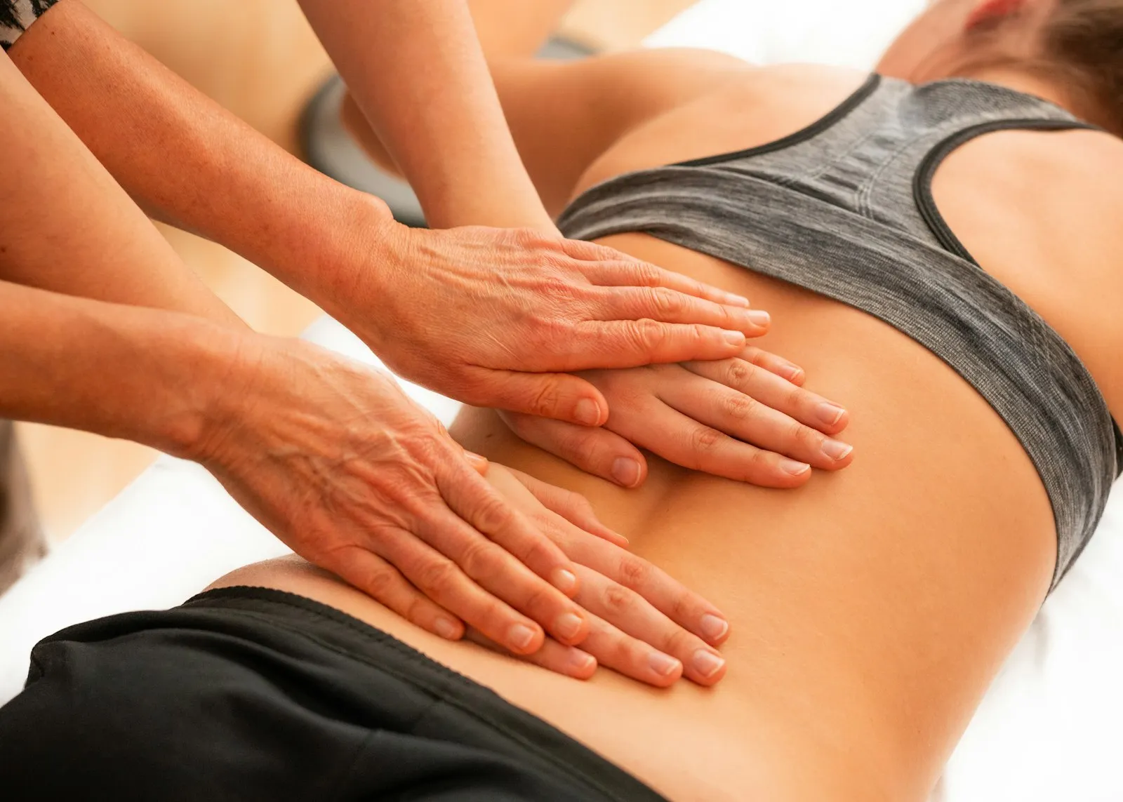 A chiropractor treating a patient on a treatment table.